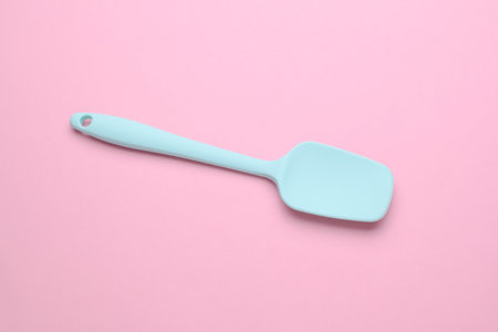 Silicone kitchen spatula on a pink backgroundの写真素材