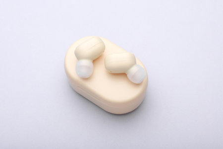 Wireless Earphones with Charging Case on gray Background