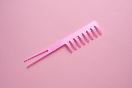 Plastic comb on pink background. Hair careの写真素材
