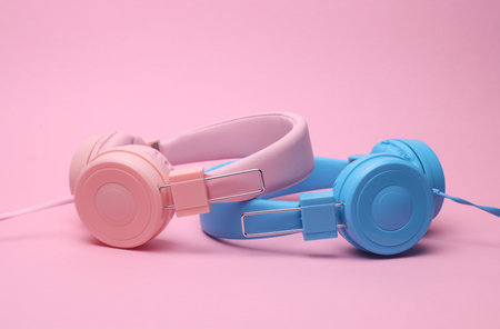 Stereo wired headphones on pink background