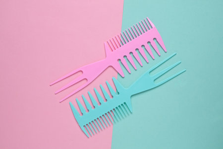 Set of plastic combs on pink blue background. Top viiew