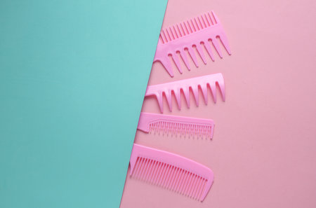 Set of plastic combs on pink blue background.の写真素材