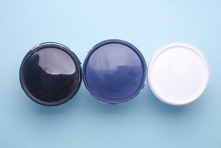 Closed paint cans on blue background. Top viewの写真素材