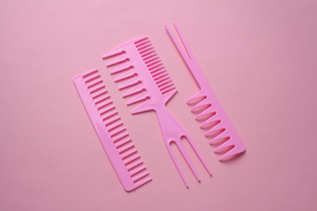Set of plastic combs on pink background.の写真素材