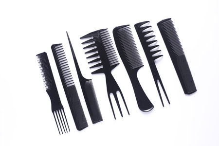Set of black plastic combs on white background