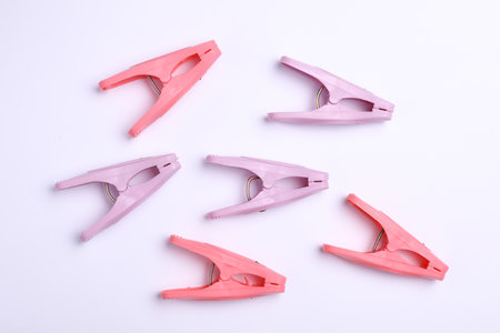 Plastic clothespins on white background. Top view