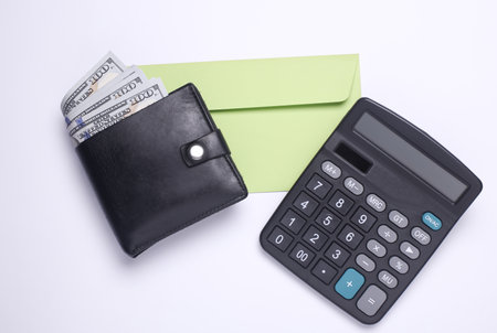 Wallet with hundred dollar bills, envelope and calculator on white background