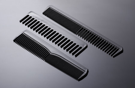 Set of plastic combs on black background close-up