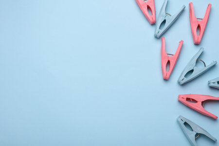 Plastic clothespins on blue background. Copy spaceの写真素材