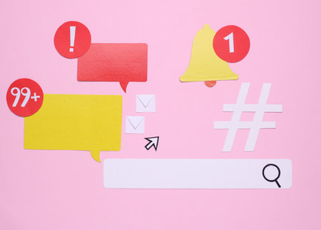 Top view of a group of social media icons on pink background.の写真素材