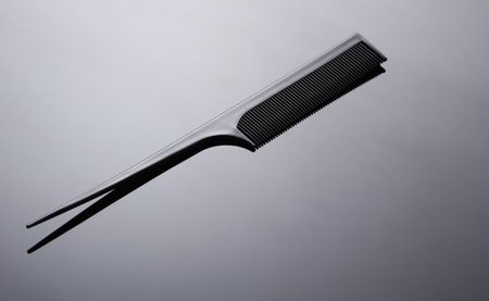 Plastic comb on black background close up