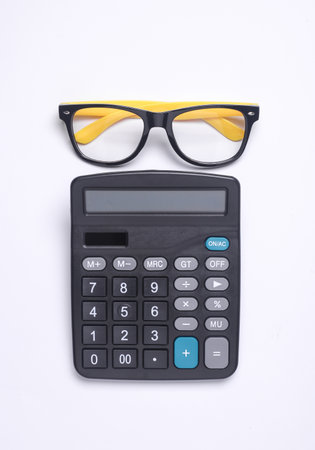 CAlculator with eyeglasses on white background