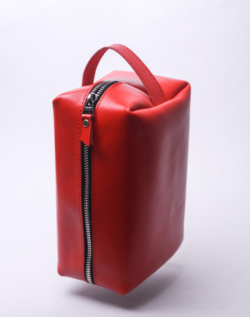 Red Leather cosmetic bag organizer floating on white backgroundの写真素材