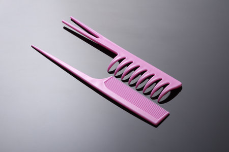 Set of pink plastic combs on black backgroundの写真素材