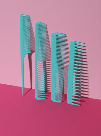 Plastic combs on pink background. Beauty concept. Creative layout. Minimalismの写真素材