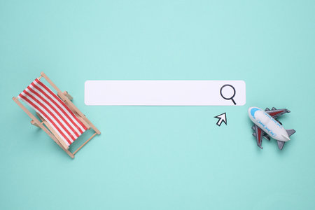 Paper search bar with cursor and toy air plane, deck chair on blue background. Travel, summer resort conceptの写真素材
