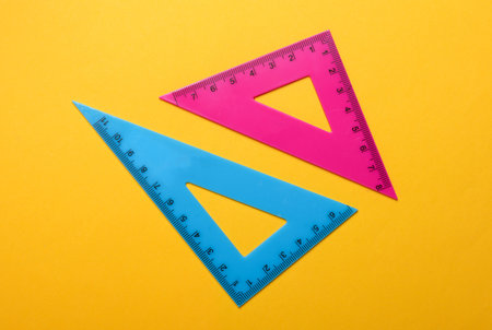Rulers triangles on yellow background. Top viewの写真素材