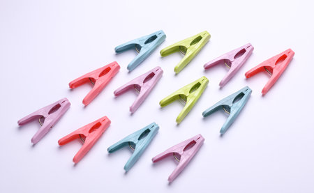 Plastic clothespins on white background. Top view