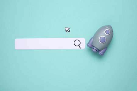 Paper search bar with cursor and rocket on blue background. Startupの写真素材