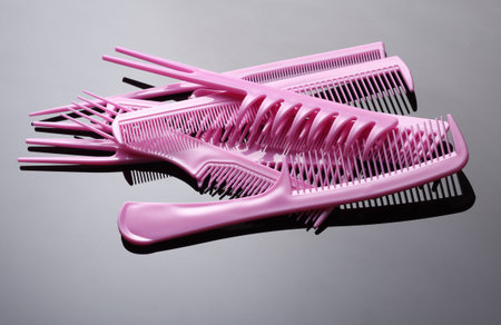 Set of pink plastic combs on black backgroundの写真素材