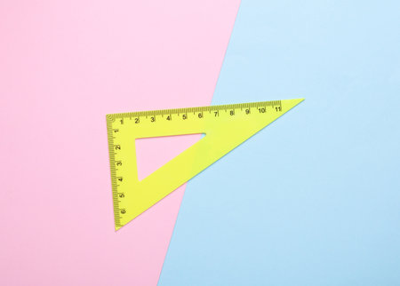 Ruler triangle on pink blue background. Top viewの写真素材
