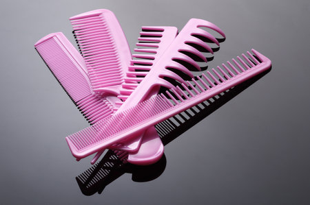 Set of pink plastic combs on black backgroundの写真素材