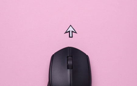 PC mouse with cursor on pink backgroundの写真素材