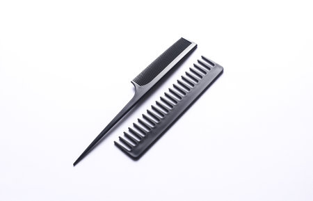 Set of black plastic combs on white background