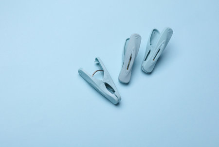 Plastic clothespins on a blue backgroundの写真素材