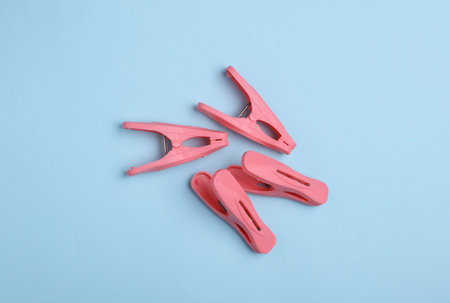 Plastic clothespins on a blue backgroundの写真素材
