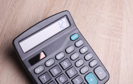 Black classic calculator on table. Top view