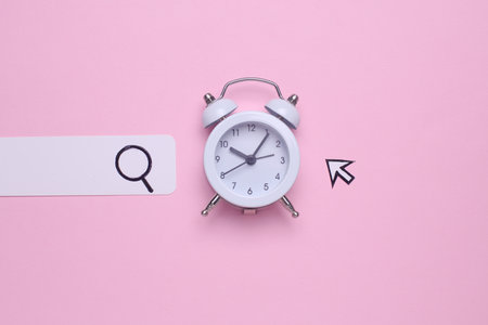 Paper search bar with cursor and alarm clock on pink background. Waiting for internet connectionの写真素材