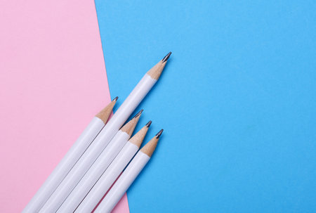 White wooden pencils on pink blue background. Mockup for designの写真素材