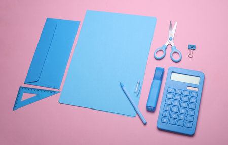 Sheets of paper with blue color school stationery on pink background. Flat lay. Creative layoutの写真素材