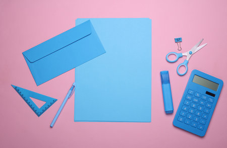 Sheets of paper with blue color school stationery on pink background. Flat lay. Creative layoutの写真素材