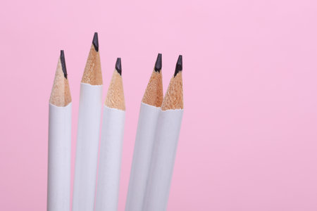Set of white wooden pencils on pink backgroundの写真素材