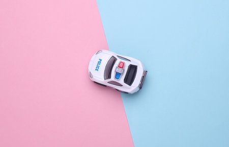Toy police car on pink blue backgroundの写真素材