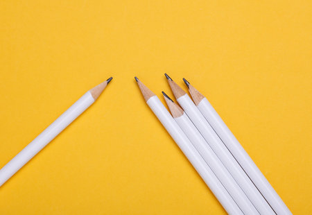 White wooden pencils on yellow background. Mockup for designの写真素材