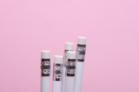 Close up of pencil erasers on pink backgroundの写真素材