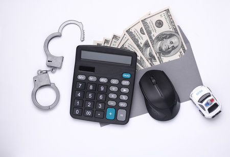 Envelope with money and handcuffs, pc mouse, calculator, police car on a white background. Corruption, crime, Cyber ââpoliceの写真素材