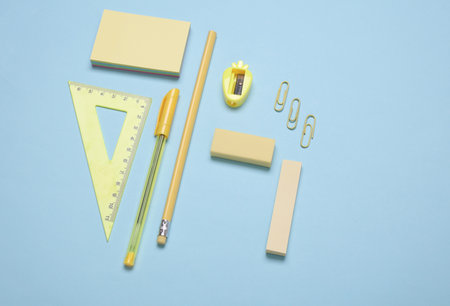 School supplies on blue background. Back to school concept. Flat lay, top view.の写真素材