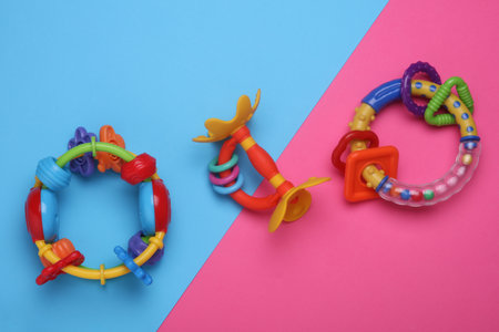 Rattles toys for newborn on pink blue backgroundの写真素材