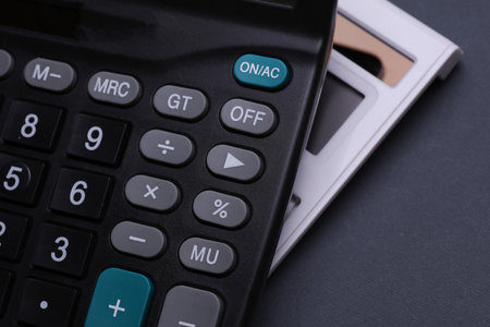 Two calculators on a dark backgroundの写真素材