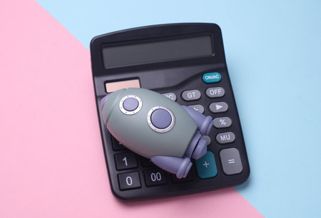 Calculator and space shuttle on blue pink background. Startup idea