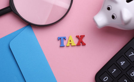 Business sccessories with word tax on pink background. Flat layの写真素材