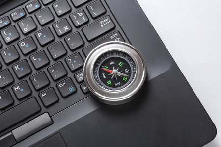 Laptop and compass on white background. Business conceptの写真素材
