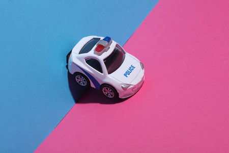 Toy police car on blue pink backgroundの写真素材