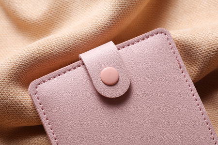 Pink leather purse on beige velour backgroundの写真素材