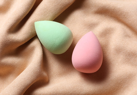 Makeup egg sponges on beige velour backgroundの写真素材