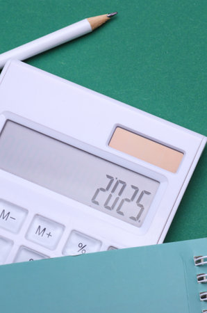 Calculator with number 2025 on green background. Economic analysis, budget of the year